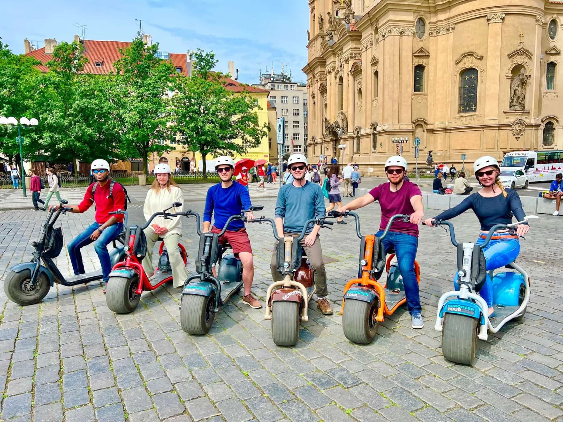 A group on colorful SCROOSERs on the square by St Nicholas Church