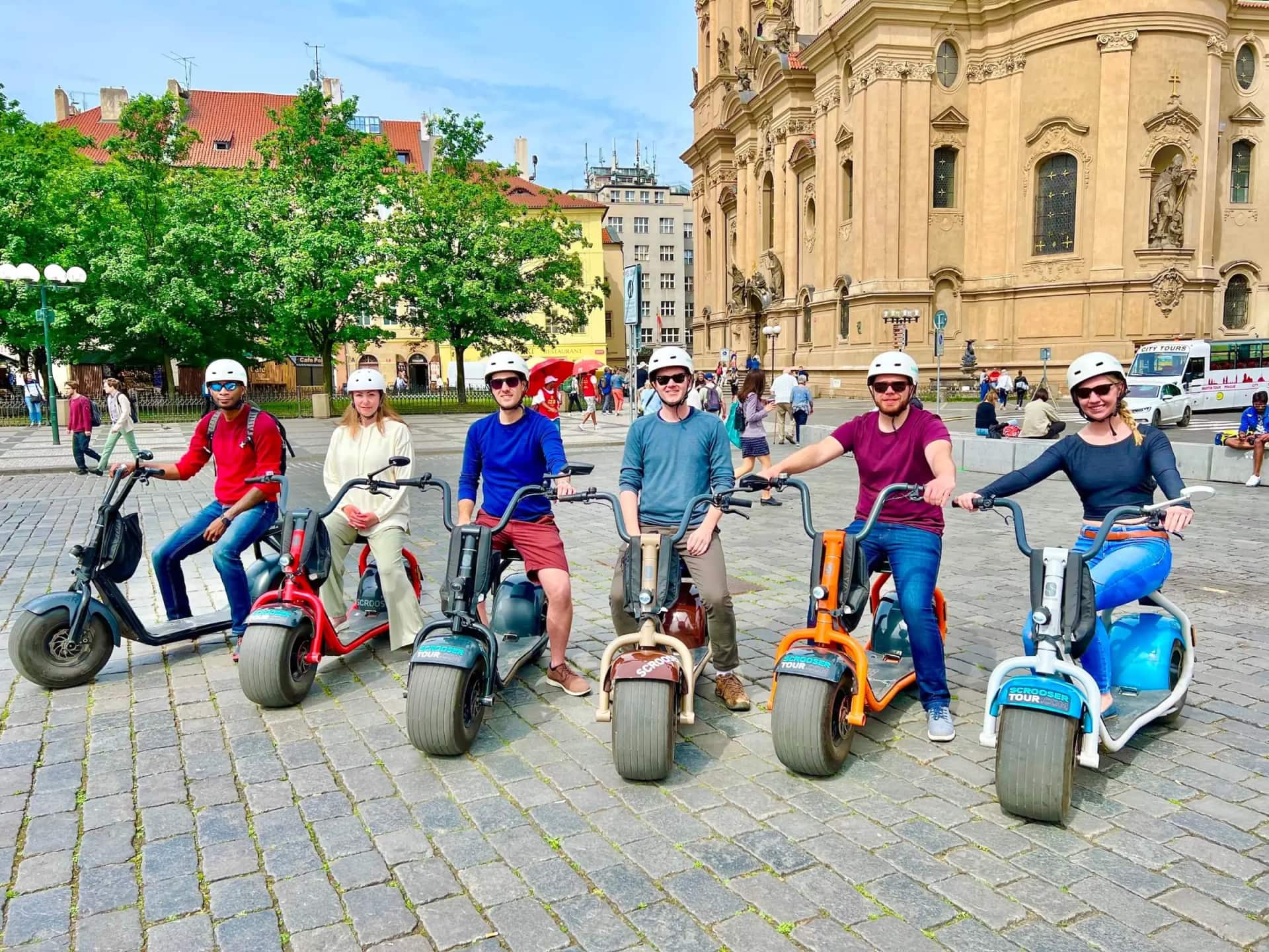 A group on colorful SCROOSERs on the square by St Nicholas Church
